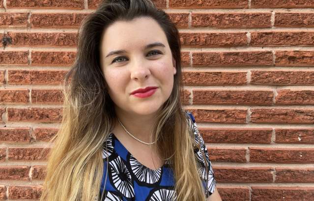 Headshot of Emma Balter posing against a brick wall