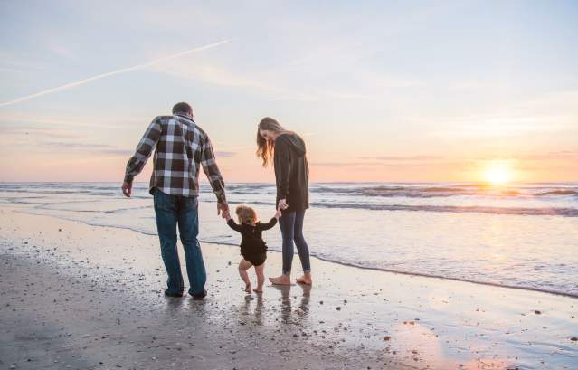 Family walking down the Port A beach at sunset.