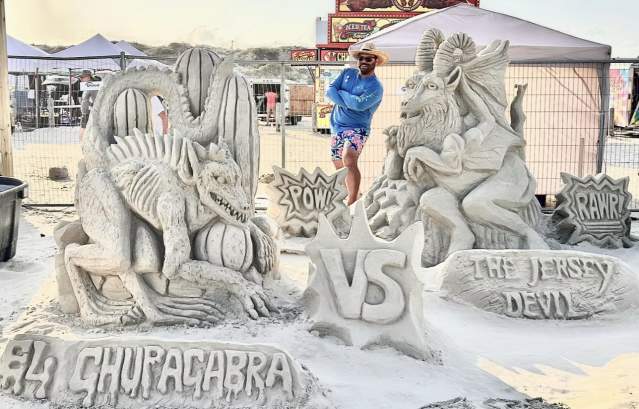 Sand sculpture of a battle between El Chupacabra and the Jersey Devil at Texas SandFest.