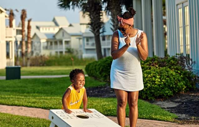 Mother and child playing cornhole in Cinnamon Shore resort