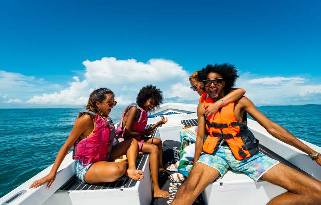 Friends enjoying a beautiful sunny day on a boat on the beaches of the Gulf of Chiriqui