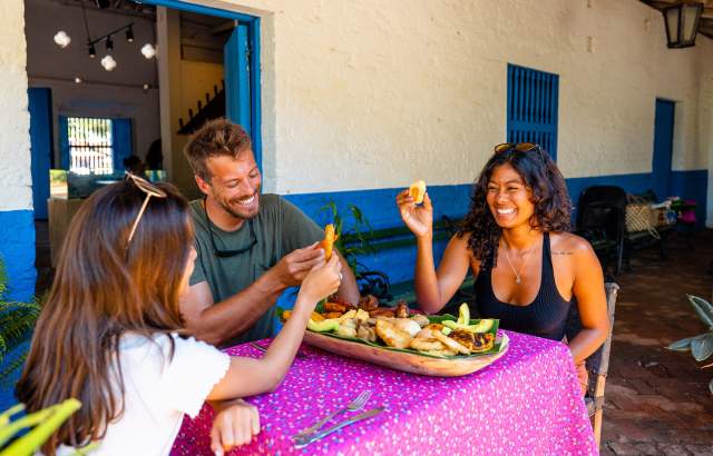 Friends eating Panamanian dish at La Villa de los Santos, Los Santos Province, Panamá