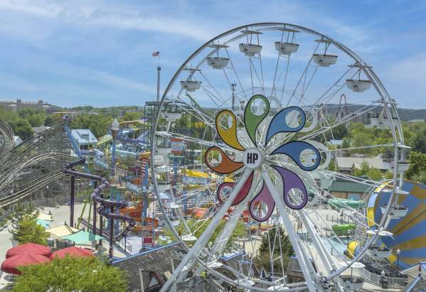 Aerial view of an amusement park with a large Ferris wheel