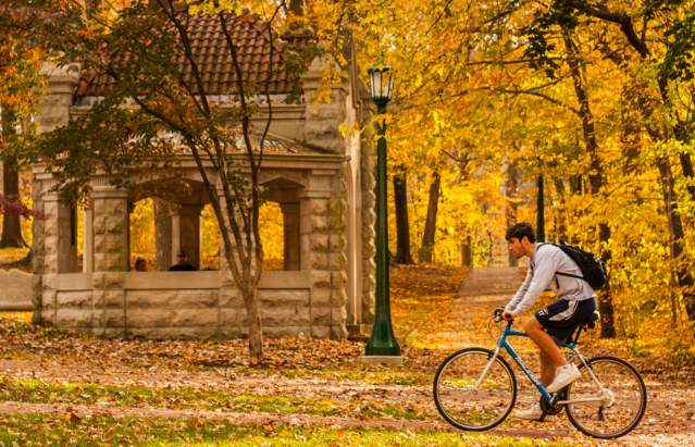 College students biking/walking on the Indiana University campus in the fall