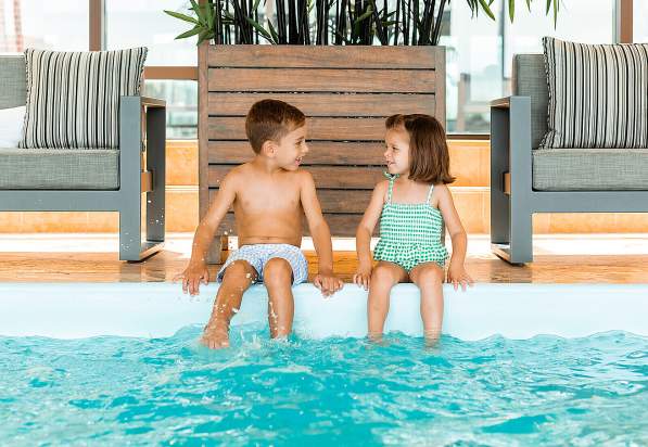 Kids at indoor pool at Four Seasons Hotel Boston