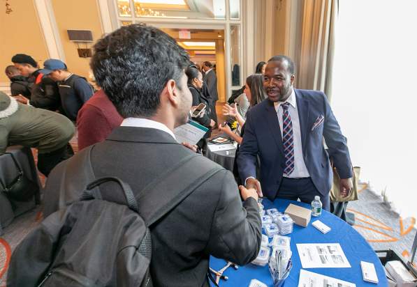 Job seeker shaking hands with employer at Meet Boston's annual Career Fair