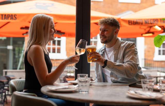 People cheersing glasses in restaurant