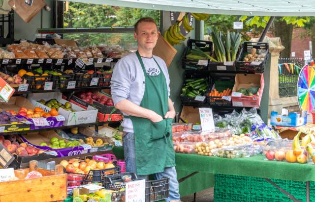 Nick, a fruit and vegetable seller based in Manchester, outside of his stall.
