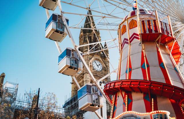 Manchester Christmas markets wheel and helter skelter with impressive town hall in the background