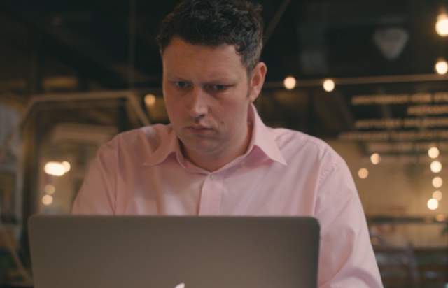 Nick Richardson, founder of the Insight People, working on his MacBook in a co-working space in Manchester