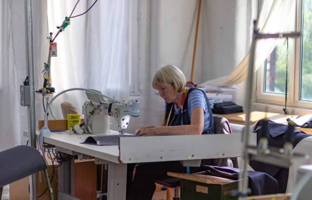 Sewing machinist Marian working on a garment