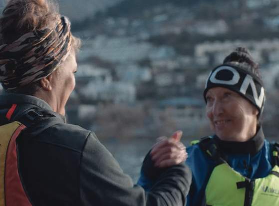 Two Queenstown women from Waka Ama embrace hands