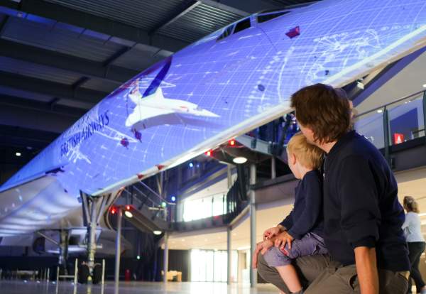 A father and son in front of the Concorde Alpha Foxtrot supersonic airliner at Aerospace Bristol - credit Adam Gasson