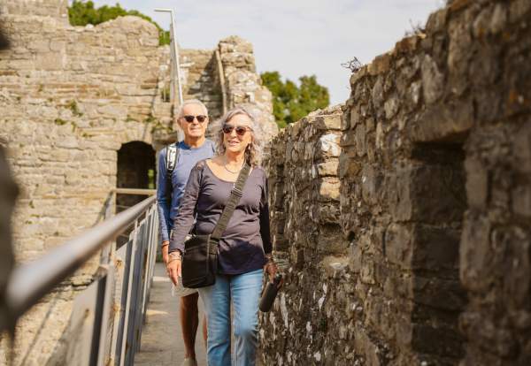 Couple walking along castle ramparts