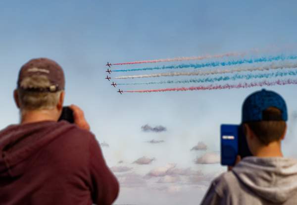 People taking photos of the red arrows at the Wales Airshow