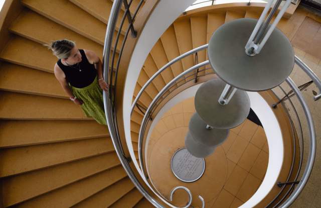 Person walking down a spiral staircase at De La Warr Pavilion
