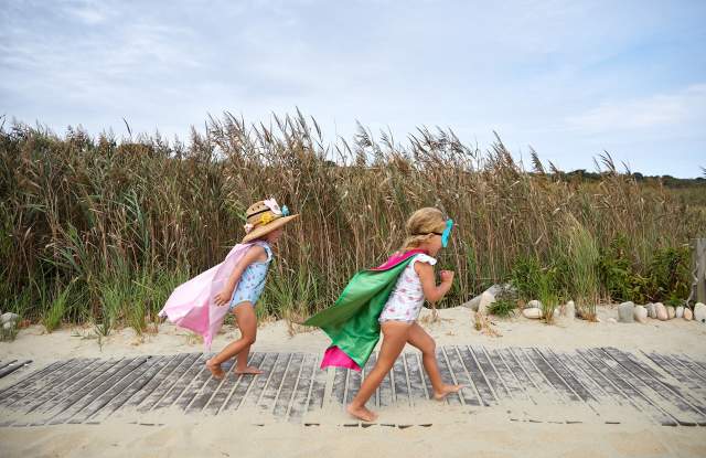 2 girls running on the beach