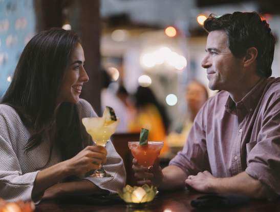 A couple enjoying drinks at Uncle Julio's at ICON Park