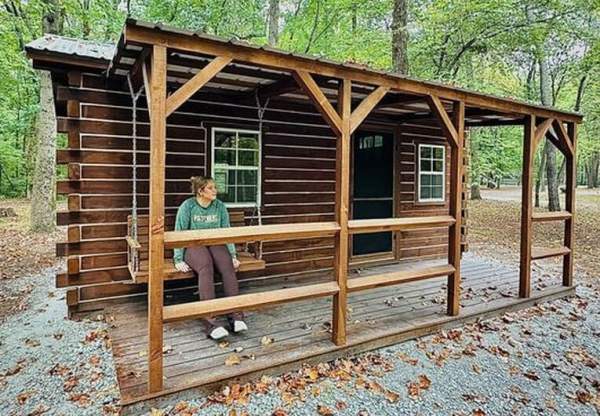 Ellen checks out the porch swing at Hawthorn Park’s newest cabin – which will be available for campers in 2025.