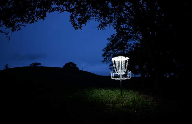 View of basket 8 on the Seven Points Pine 9 Disc Golf Course lit up at night