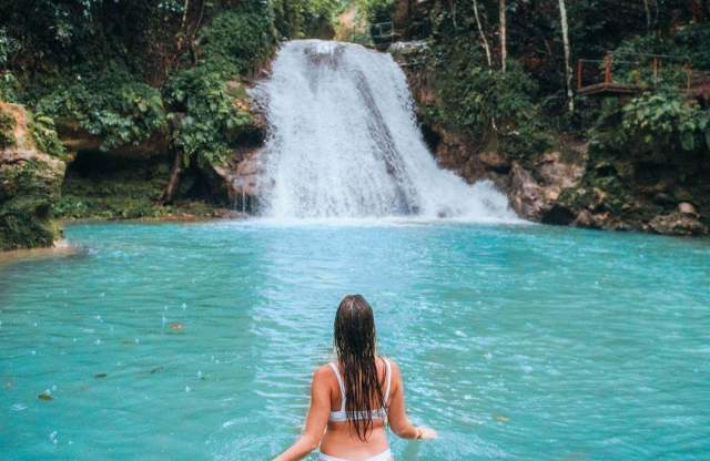 Woman in front of a waterfall