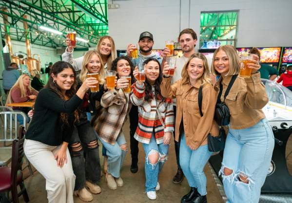Group raising their glass for a toast to the Pour Tour