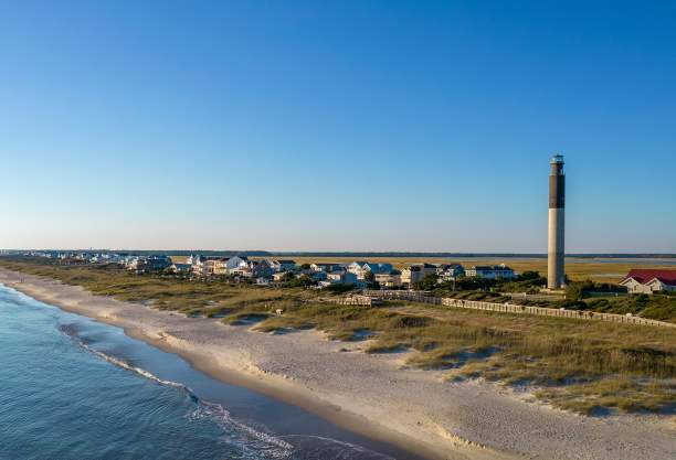 an aerial view of the OKI Lighthouse and Caswell Beach, NC