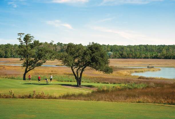 Foursome on Rivers Edge Golf Club's 9th green.