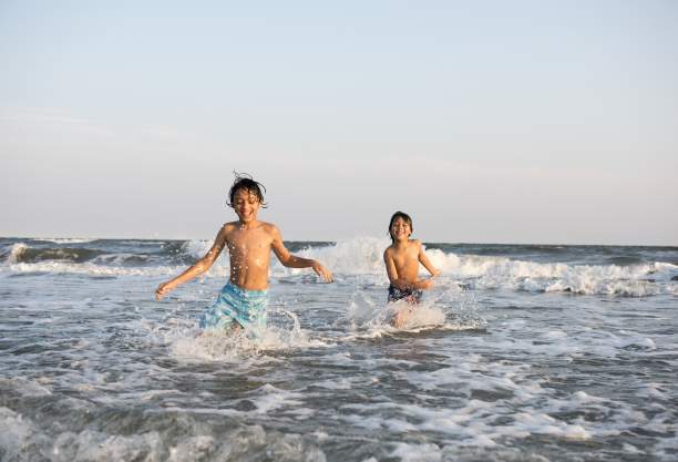 Boys playing in the surf at family friendly beach