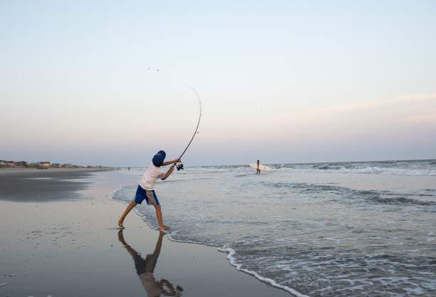 Boy surf fishing on Ocean Isle Beach