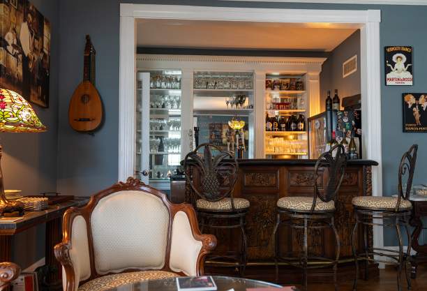 a parlor room with a bar and chairs