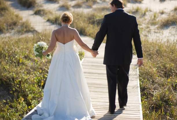 married couple walking on board walk