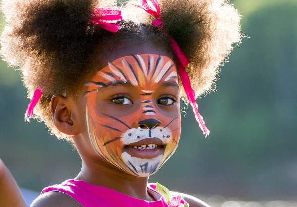 Young girl with face painted at downtown event