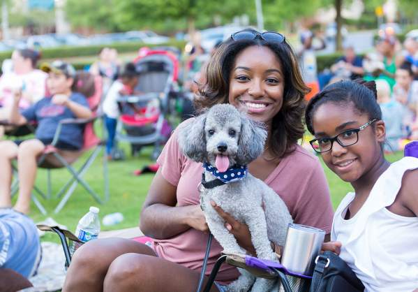 Mom and Daughter w/ Dog at outdoor concert