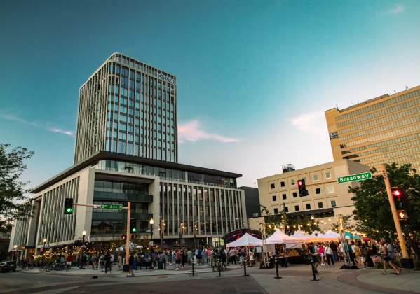 group of people gathering for an event with local vendors in the heart of a downtown