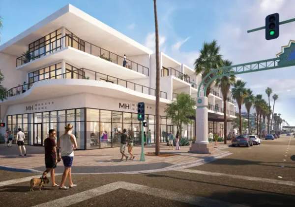 A sunny streetscape with modern two-story white buildings on the left, palm trees lining the road, pedestrians, some with a dog, crossing the street, cars on the road, and a traffic light showing green.