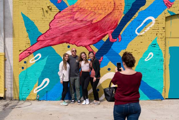 Family taking pictures and experiencing the fun at the Mural Festival in Beaumont, Texas!