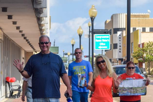 A group of people enjoying touring the geocaching attractions in downtown Beaumont.