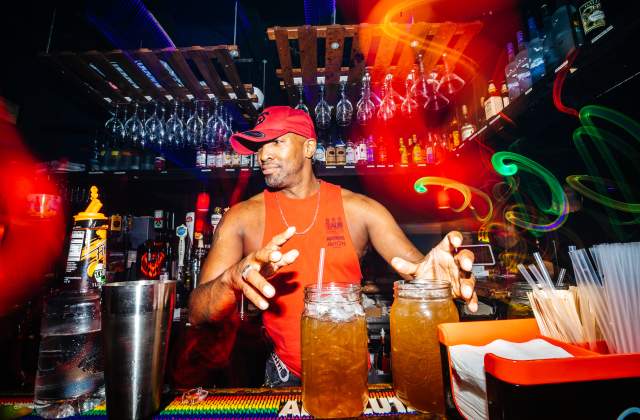 The bartender at Georgie's Alibi mixes cocktails for guests.