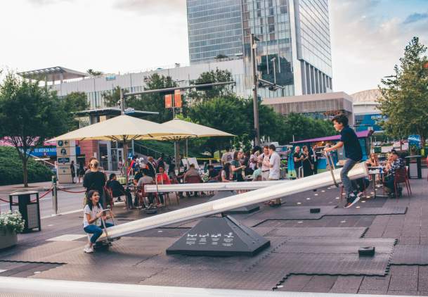 Children On a Seesaw At The Impulse Sneak Preview Event In Houston, TX