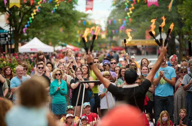 gathering of people celebrating fire dancer