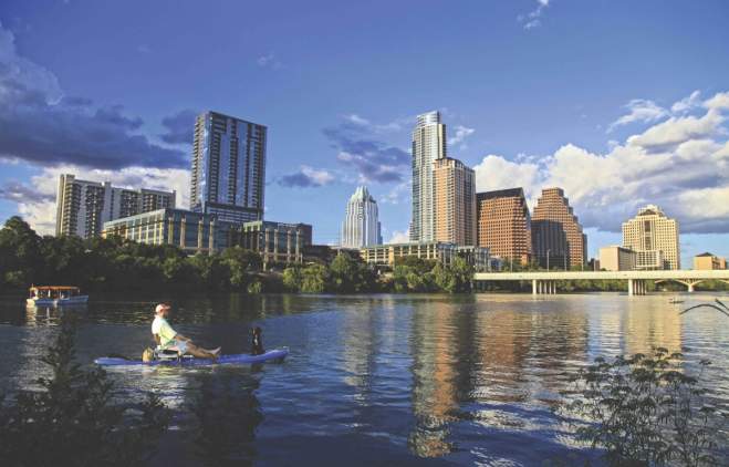 downtown austin texcas Skyline with man in kayak with dog
