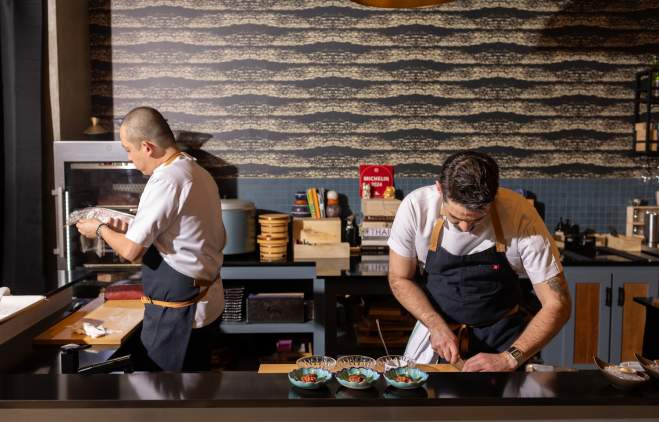 Chefs at Craft Omakase focused on plating dishes.
