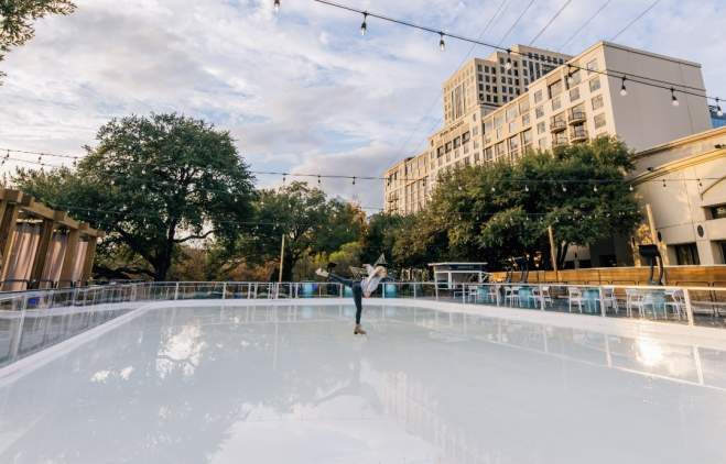 Woman skating on shiny ice outside of the Four Seasons Hotel Austin.