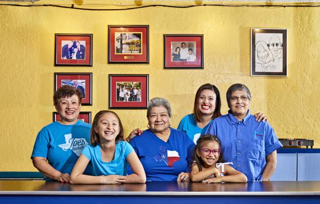 Regina Estrada and female family members smile for a portrait inside Joes Bakery and Coffee Shop
