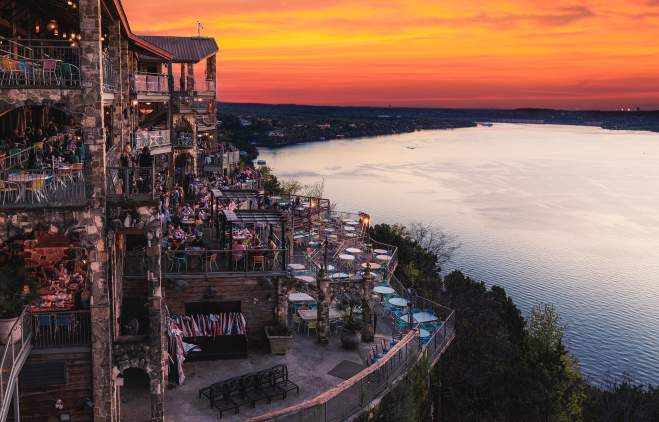 Image of the deck overlooking Lake Travis at the Oasis at sunset.