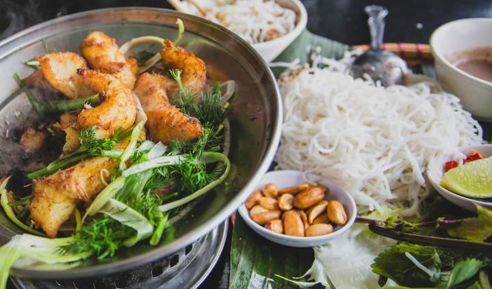 Turmeric and dill fish with herbs, rice noodles and dipping sauce at Hanoi Corner in Anaheim, CA.