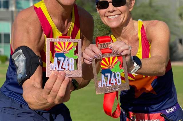 AZ48 Half Marathon Runners Holding Finisher Medals