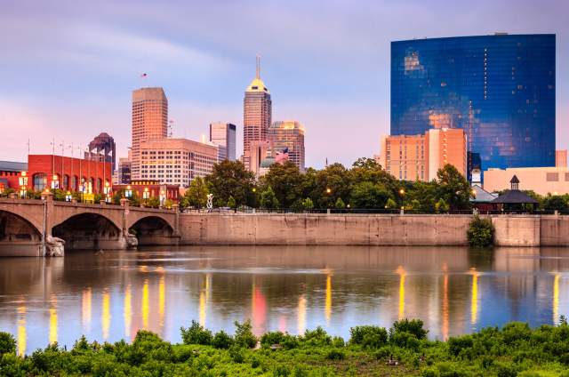 The White River reflects the Indianapolis skyline