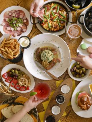 Round wooden table filled with various dishes for Carlisle dining